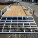 a Sport Haven trailer with a wooden deck and a metal ramp