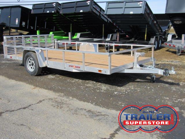 a silver trailer with a wooden deck is parked on the side of the road