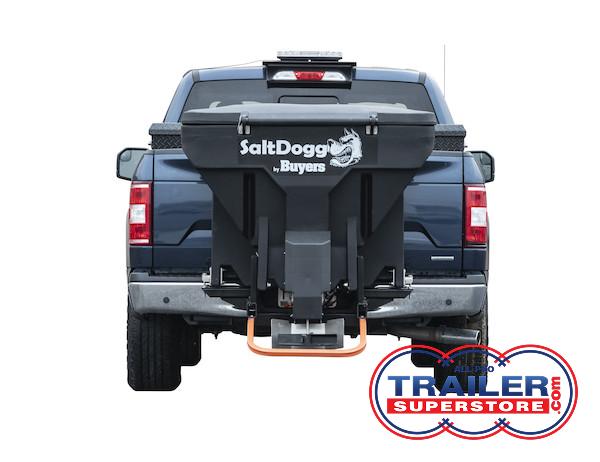 the back of a blue truck with a salt spreader attached to it .