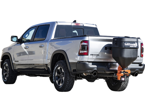 a silver ram truck with a salt spreader attached to the back of it