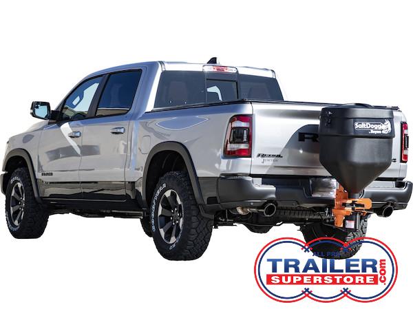 a silver ram truck with a salt spreader attached to the back of it