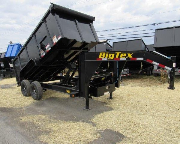 a dump trailer is parked on the side of the road