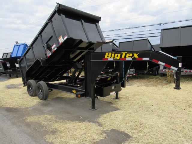 a dump trailer is parked on the side of the road
