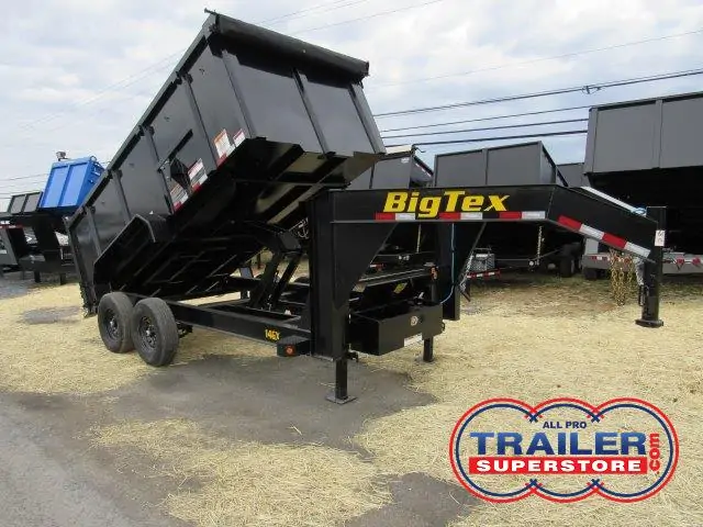 a dump trailer is parked on the side of the road