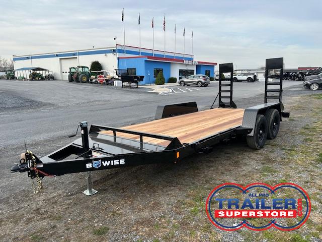 a bwise trailer is parked in a parking lot in front of a building .
