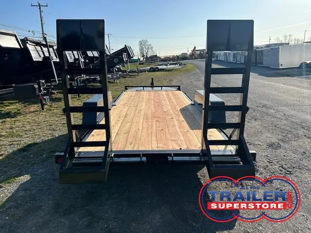 a trailer with a wooden deck is parked in a parking lot .