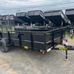 a black bigtex trailer is parked on the side of the road