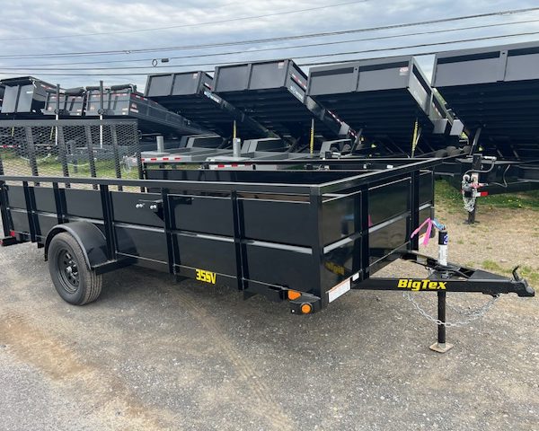 a black bigtex trailer is parked on the side of the road