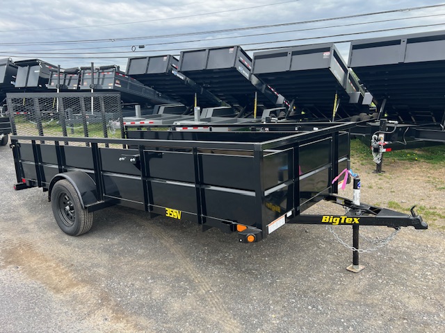 a black bigtex trailer is parked on the side of the road