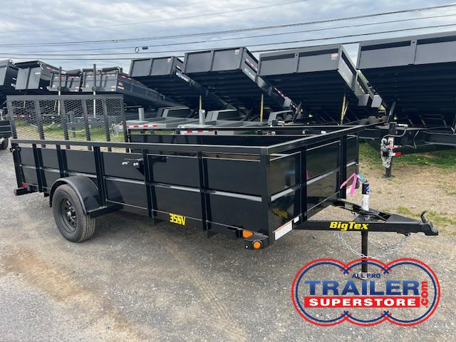 a black bigtex trailer is parked on the side of the road