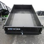 a bwise trailer is parked on the side of the road .