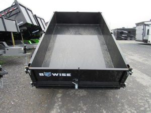 a bwise trailer is parked on the side of the road .