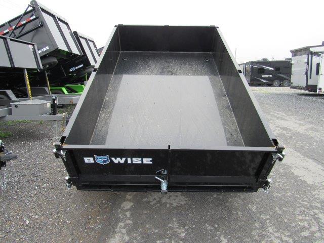 a bwise trailer is parked on the side of the road .