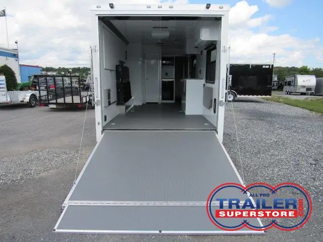the back of a trailer with the door open and a ramp .