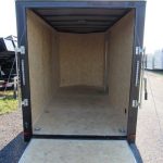 the inside of an empty trailer is shown with the door open