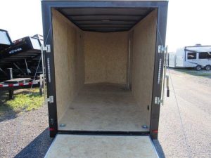 the inside of an empty trailer is shown with the door open