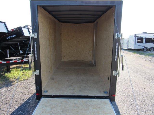 the inside of an empty trailer is shown with the door open