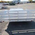 a silver trailer parked in a parking lot .