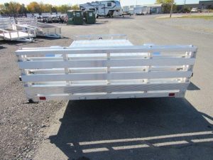 a silver trailer parked in a parking lot .