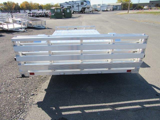 a silver trailer parked in a parking lot .