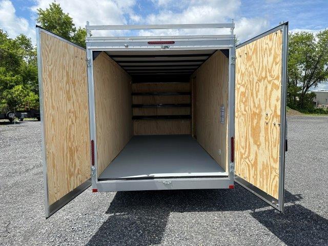 the inside of a trailer with the doors open is empty .