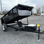 a Premier dump trailer is parked in a raised position