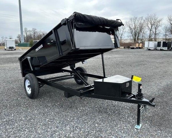 a Premier dump trailer is parked in a raised position