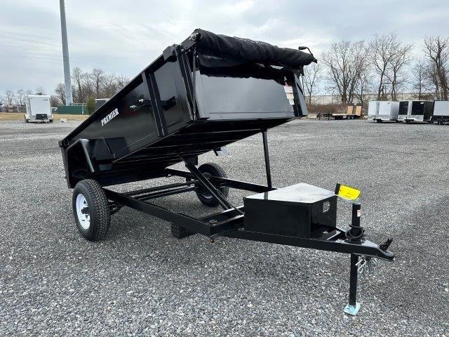 a Premier dump trailer is parked in a raised position