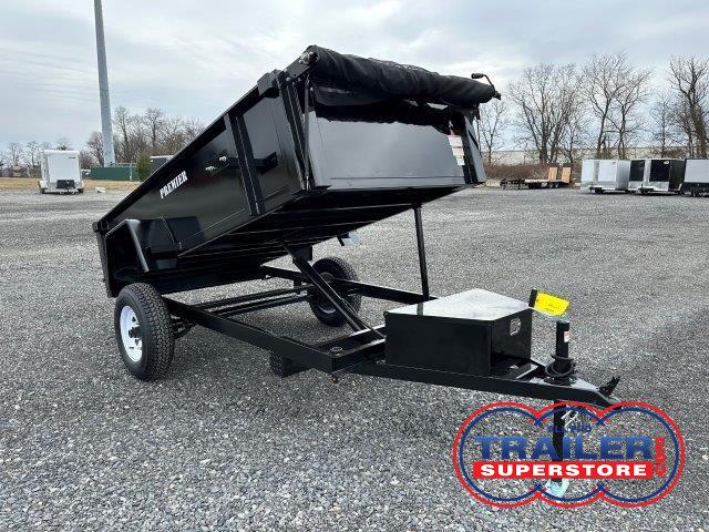 a Premier dump trailer is parked in a raised position