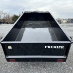 a Premier dump trailer parked in a gravel lot
