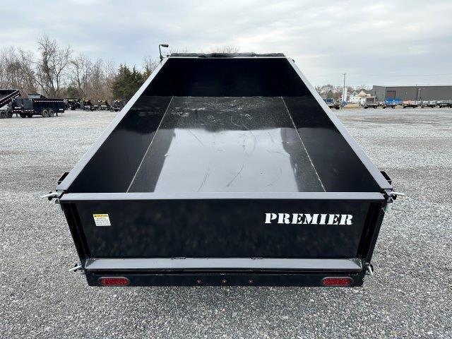 a Premier dump trailer parked in a gravel lot