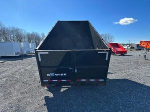 a black bwise trailer in a gravel lot