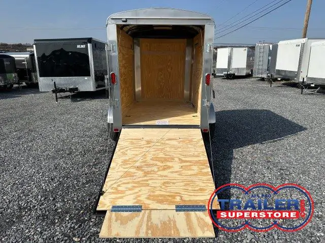 a Carry-On 5x8 enclosed cargo trailer with an open ramp door