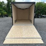 an ATC trailer with the door open parked in a gravel lot