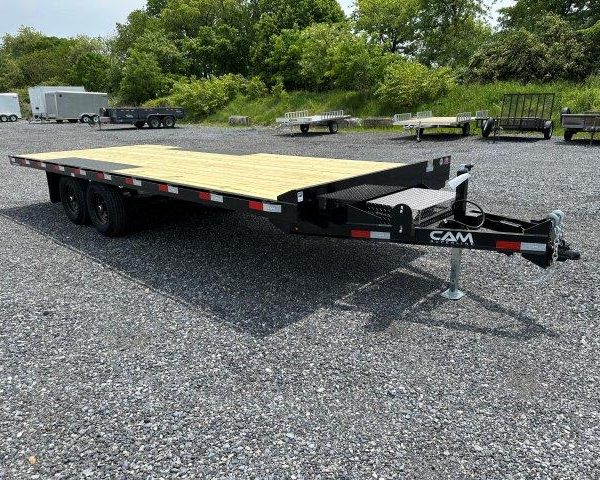 a CAM Superline deckover equipment trailer with slide out ramps