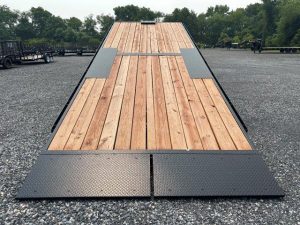 a Bwise wooden deck parked in a gravel lot