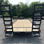 the back of a trailer with a wooden deck and ladder