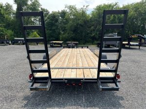 the back of a trailer with a wooden deck and ladder