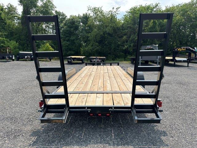 the back of a trailer with a wooden deck and ladder