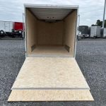 an ATC trailer with the door open parked in a gravel lot