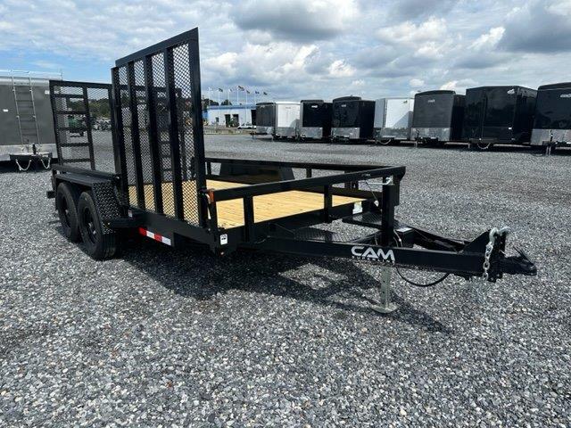 a black trailer parked in a gravel lot
