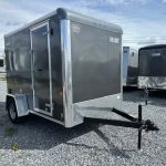 a Car Mate trailer parked in a gravel lot