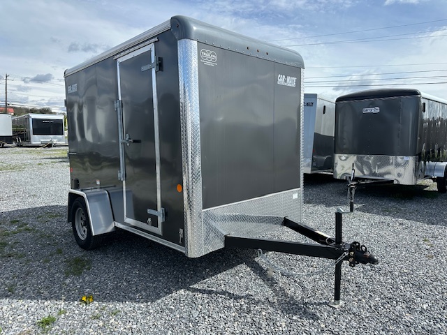 a Car Mate trailer parked in a gravel lot
