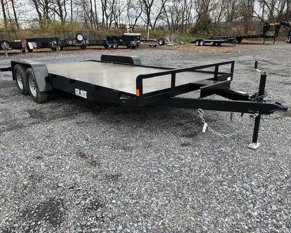 a Car Mate flatbed trailer parked in a gravel lot