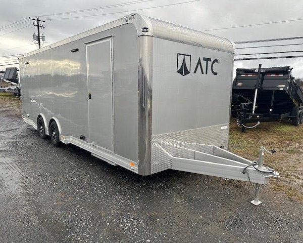 an ATC trailer parked in a gravel lot