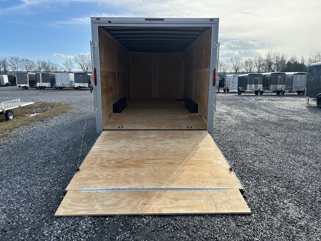 a Homesteader trailer with the door open parked in a gravel lot