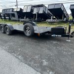 an open car trailer with power tilt, steel deck, and aluminum wheels