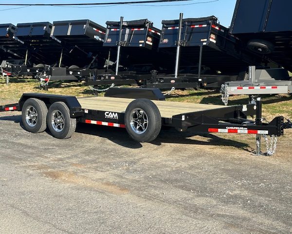 a CAM Superline trailer parked next to a row of dump trailers