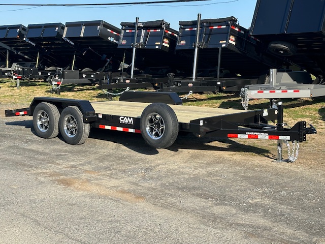 a CAM Superline trailer parked next to a row of dump trailers