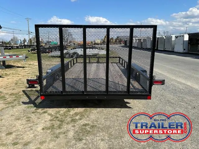 a black trailer with a mesh fence is parked on the side of the road